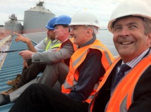 From left, Will Cottrell, of Brighton Energy Co-op, with Climate Change Minister Greg Barker, Hove MP Mike Weatherley and Shoreham Port chief executive Rod Lunn on the roof of Shed 10 at Shoreham Harbour