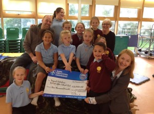 Whitehawk After School Project children and play worker Gary Allan with Caroline Ridley, CEO of Impact Initiatives, receive funding from Sussex police and crime commissioner Katy Bourne