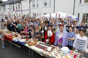 Brighton and Hove Mayor Lynda Hyde cuts the Shakespeare Street cake surrounded by Residence of the Hove Street during the Big Lunch 2015.  The Big Lunch is a very simple idea from the Eden Project. The aim is to get as many people in the UK as possible to have lunch with their neighbours on one day; to share lunch and a few hours of community, friendship and fun.