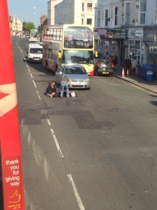 The cyclist being helped by passers-by this morning