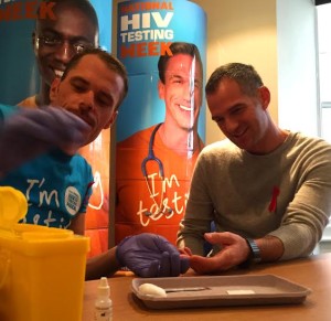 Tom Boyt checks Peter Kyle as the Hove MP encourages people to have an HIV test as part of an awareness campaign