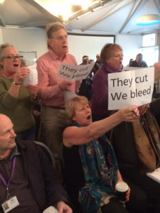The Brighton and Hove City Council budget meeting was interrupted at the start by singing protesters 