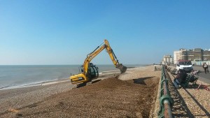 Diggers move the shingle down the beach now the winter storms have passed - by Emma Moore