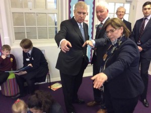 Children from Roedean help pupils at the City Academy Whitehawk in the school's reading zone as Prince Andrew speaks with City Academy head David Williams and Sharon Maguire from Roedean