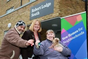 Councillor Anne Meadows welcomes new Robert Lodge residents Tekin Akkurt, left, and Sylviane Cayrol, with her dog Tilly