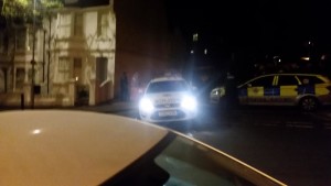 A man is driven away in handcuffs after a three-hour siege in Evelyn Terrace, Brighton, this evening