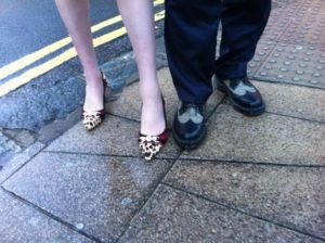 Best foot forward - Theresa May and Simon Kirby in Kemp Town - one wearing leopard print kitten heels and the other in his trademark Doc Martens