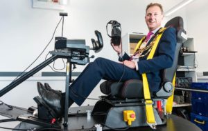 Brighton and Hove Mayor Pete West tries a flight simulator at Brighton University