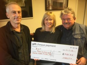 Tim Brown, from Cinecity, hands over a cheque to Jo Berry and Bill Randall from BHT