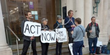 Climate activists chain themselves to bank railings