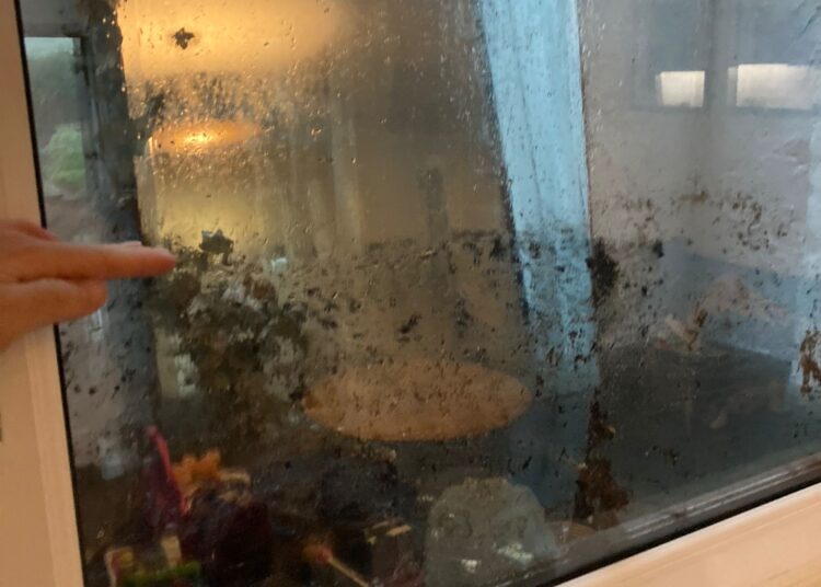 Owner of flooded house calls on council to clear drain blocked with building waste