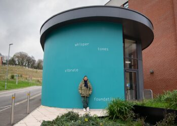 Artist Helen Cammock by her new permanent artwork on University of Sussex campus.