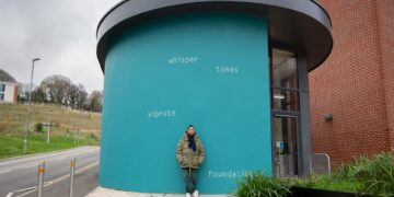 Artist Helen Cammock by her new permanent artwork on University of Sussex campus.
