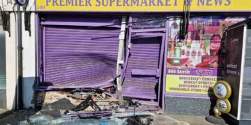 Man arrested after car crashes into shop