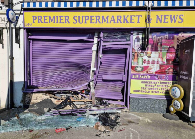 Man arrested after car crashes into shop