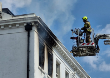 Fire crews battle flat fire